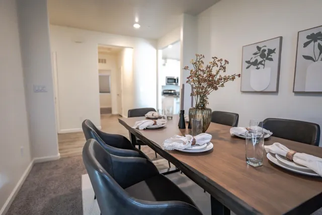 a dining room with furniture and wooden floor
