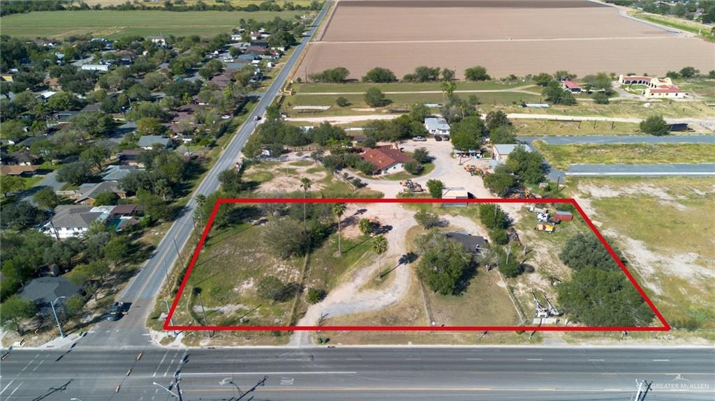 1247 South Alamo Road Alamo, TX 78516 - Photo 2 of 9 a view of a lake with a large building and couple of cars parked in front of it