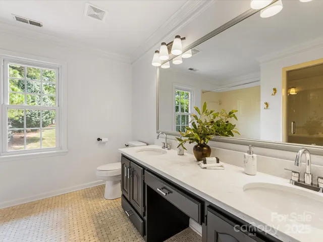 a bathroom with a sink double vanity and a mirror
