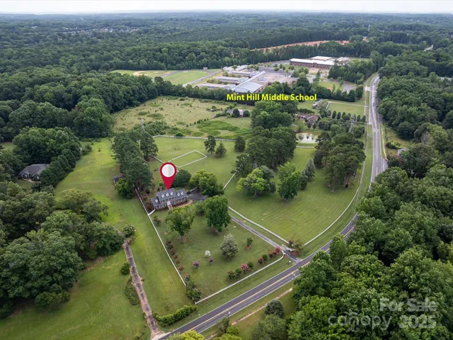 an aerial view of a residential houses with outdoor space and swimming pool