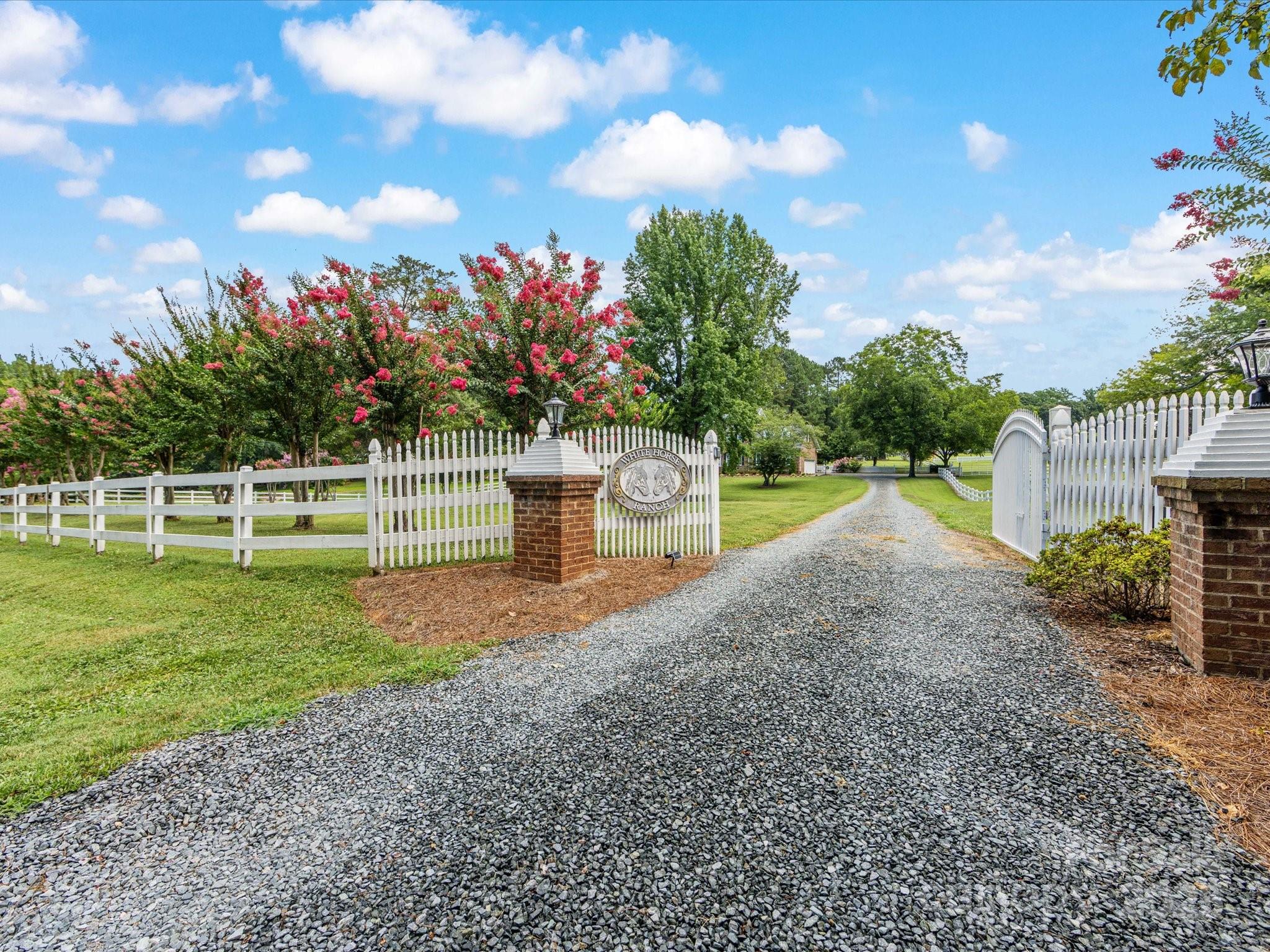 11215 Idlewild Road Matthews, NC 28105 - Photo 5 of 48 a front view of a house with a yard and a garden