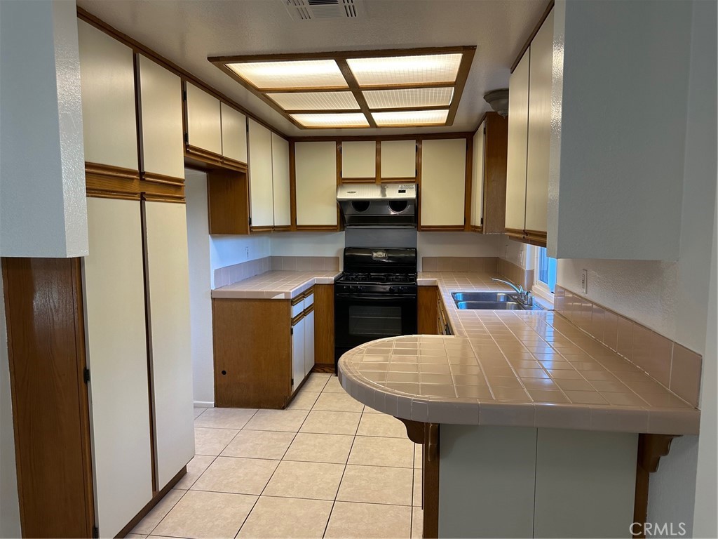11705 Ramona Boulevard El Monte, CA 91732 - Photo 4 of 15 a kitchen with stainless steel appliances kitchen island granite countertop a refrigerator a sink and dishwasher