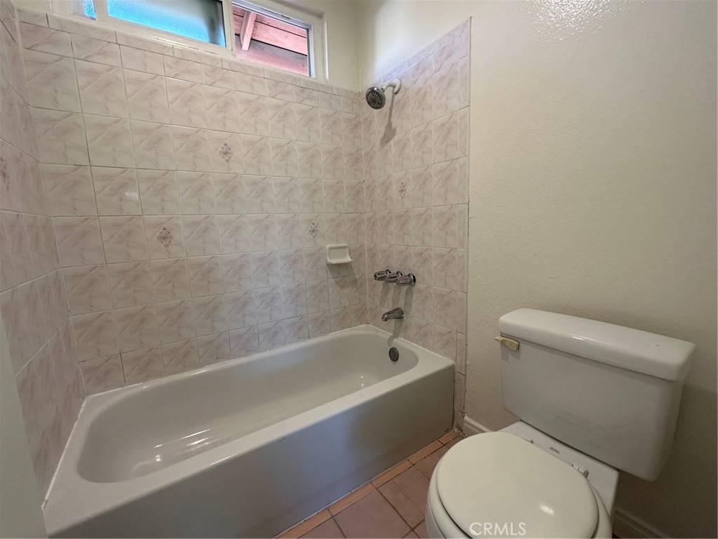 11705 Ramona Boulevard El Monte, CA 91732 - Photo 10 of 15 a white bath tub sitting next to a toilet