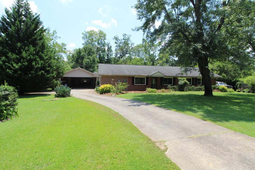 114 Keown Road Southeast Rome, GA 30161 - Photo 1 of 1 a front view of a house with garden and trees