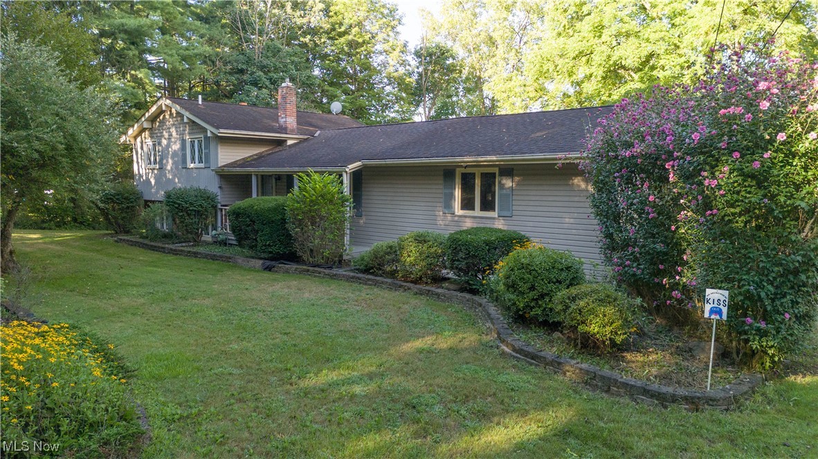 7840 Carter Road Northfield, OH 44067 - Photo 3 of 15 View of side of property with a lawn and a chimney