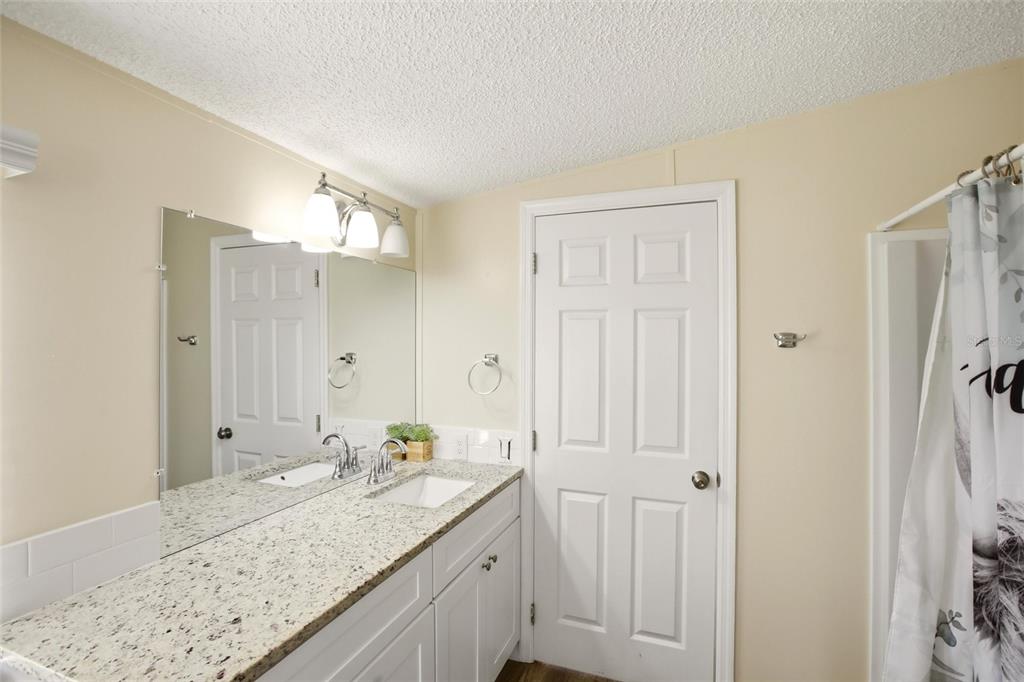 12368 Lexington Place Arcadia, FL 34269 - Photo 14 of 31 a bathroom with a granite countertop sink and a mirror