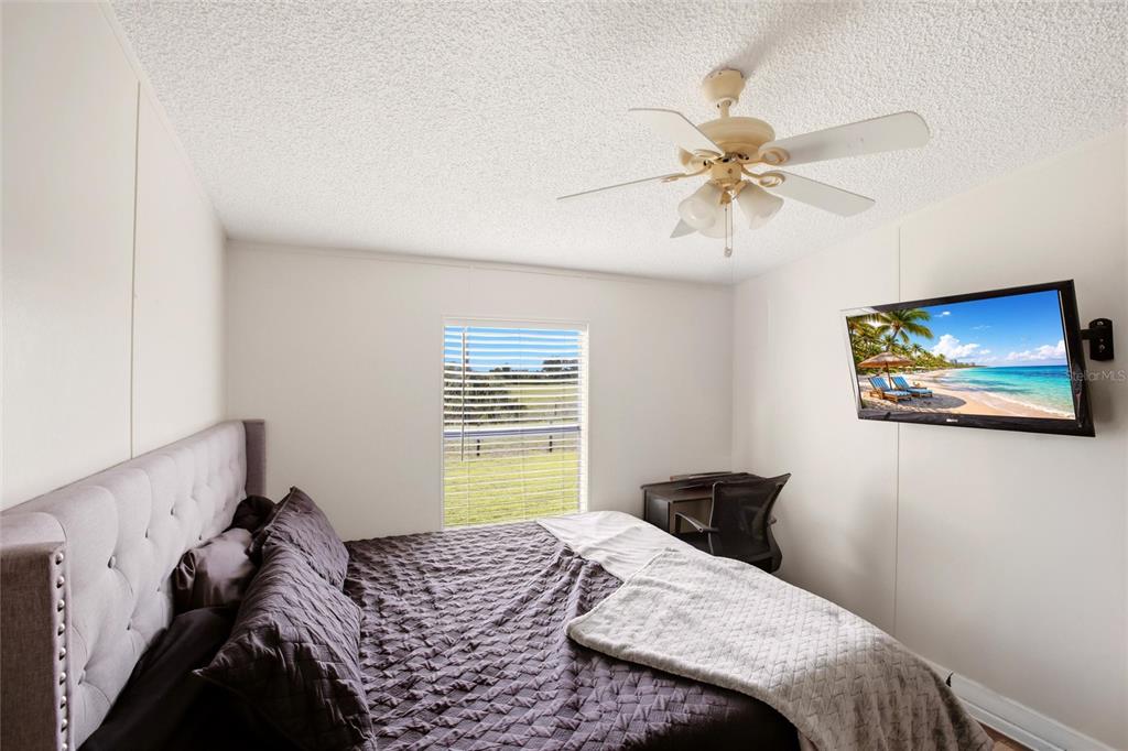 12368 Lexington Place Arcadia, FL 34269 - Photo 15 of 31 a bedroom with a bed and a chandelier
