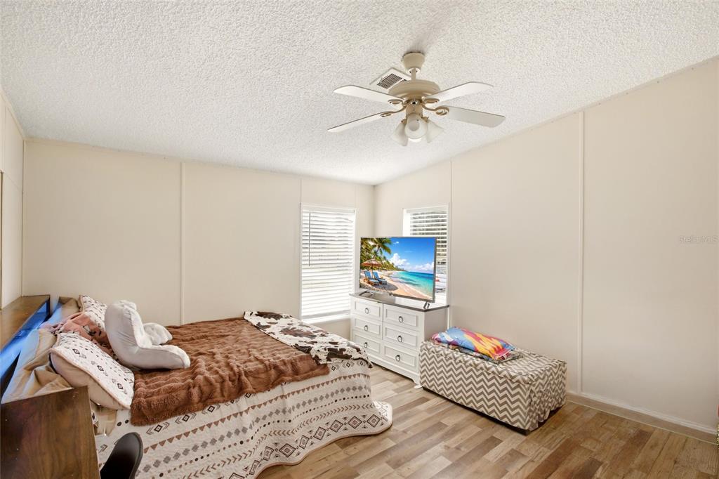 12368 Lexington Place Arcadia, FL 34269 - Photo 20 of 31 a bedroom with a bed and a chandelier