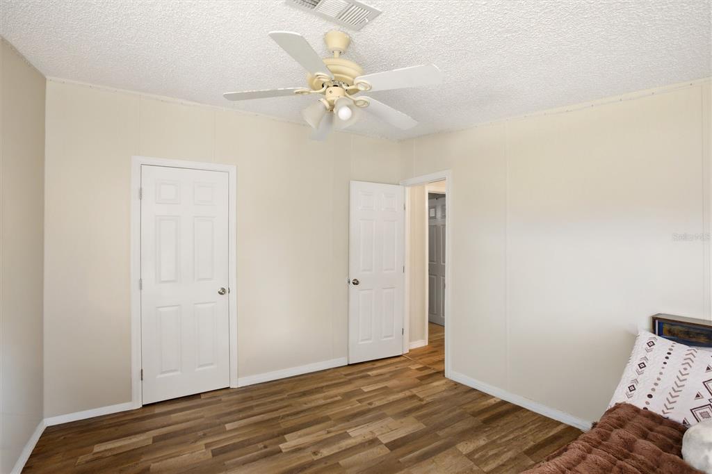 12368 Lexington Place Arcadia, FL 34269 - Photo 21 of 31 a view of a bedroom with wooden floor and closet