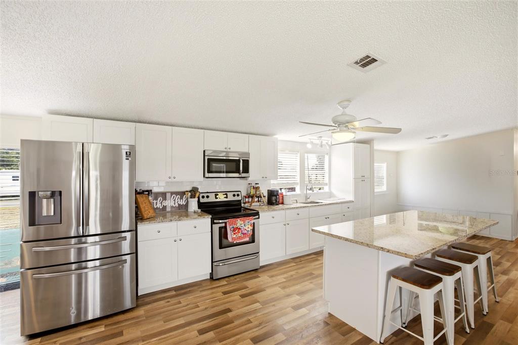 12368 Lexington Place Arcadia, FL 34269 - Photo 6 of 31 a kitchen with stainless steel appliances a refrigerator sink and stove