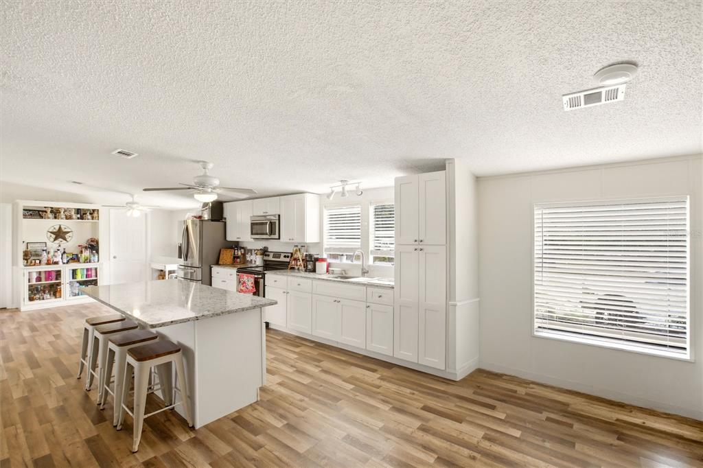 12368 Lexington Place Arcadia, FL 34269 - Photo 7 of 31 a living room with stainless steel appliances granite countertop furniture and a kitchen view