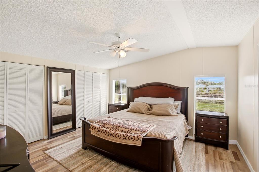 12368 Lexington Place Arcadia, FL 34269 - Photo 10 of 31 a bedroom with a large bed and a chandelier