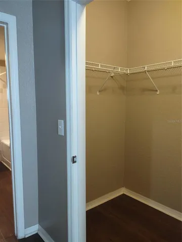 a view of a room with wooden floor and a window