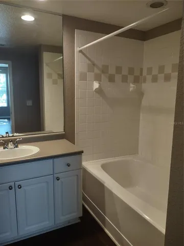 a bathroom with a bathtub and a sink