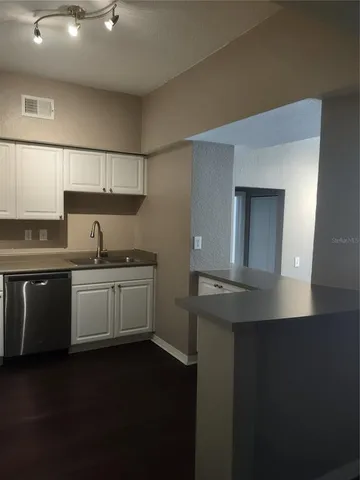 a kitchen with a sink and a refrigerator