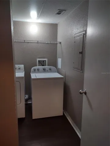 a utility room with a sink dryer and washer