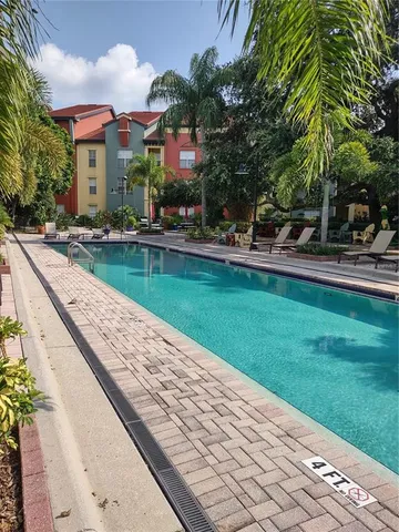 a front view of a house with swimming pool having outdoor seating