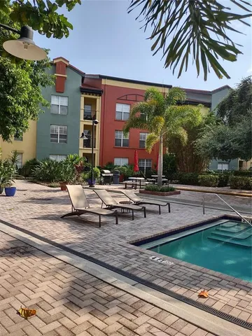 a view of a lake with a yard and palm trees