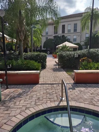 a view of a patio with a table and chairs under an umbrella