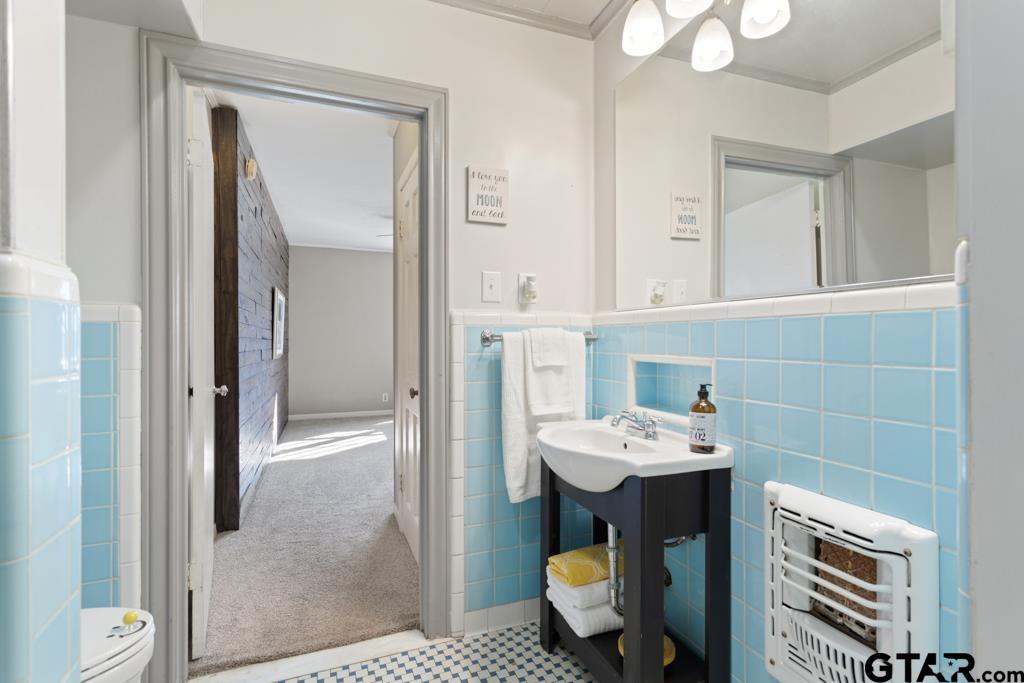205 North Henry Street Lindale, TX 75771 - Photo 18 of 36 a bathroom with a sink toilet and mirror