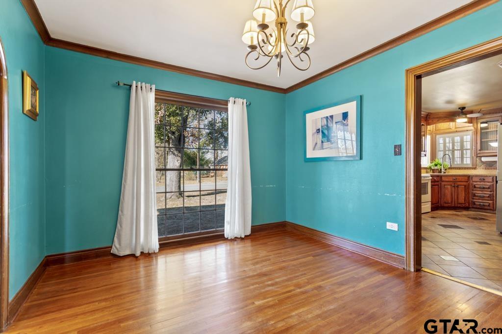 205 North Henry Street Lindale, TX 75771 - Photo 6 of 36 a view of a room with wooden floor ceiling fan and windows