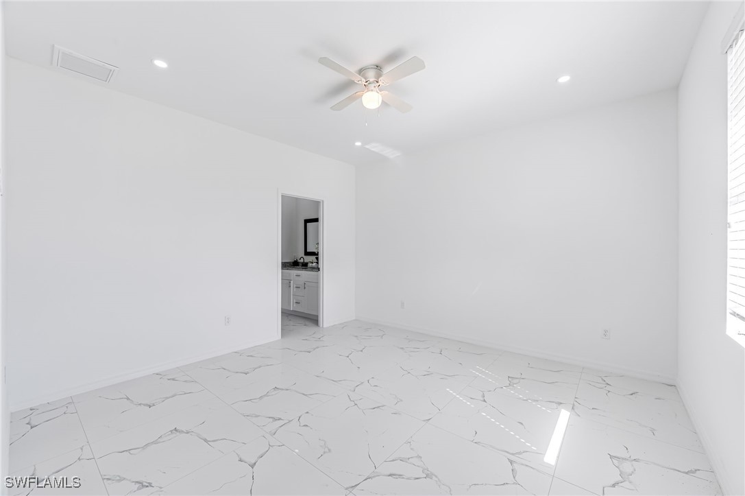 2102 Robert Avenue Alva, FL 33920 - Photo 13 of 24 an empty room with a ceiling fan and carpet