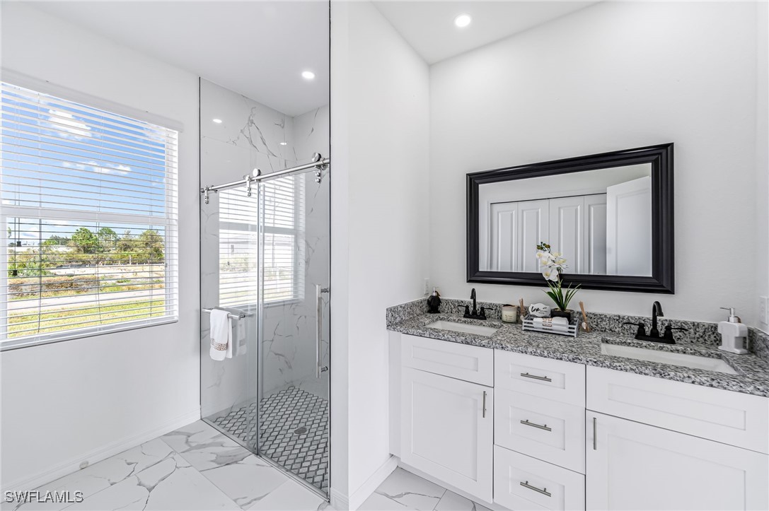 2102 Robert Avenue Alva, FL 33920 - Photo 17 of 24 a bathroom with a granite countertop sink mirror and double