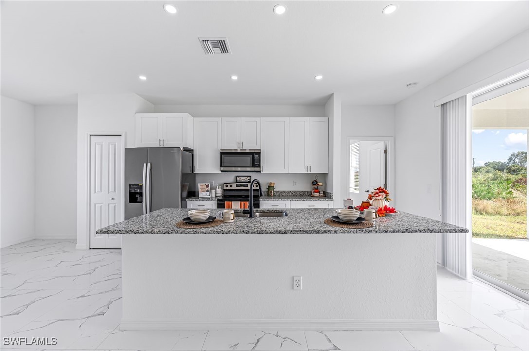 2102 Robert Avenue Alva, FL 33920 - Photo 9 of 24 a kitchen with sink cabinets and stainless steel appliances