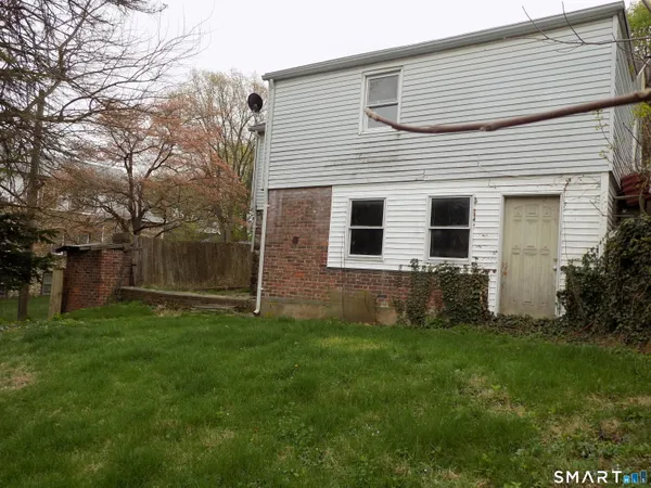 a view of a backyard with large tree