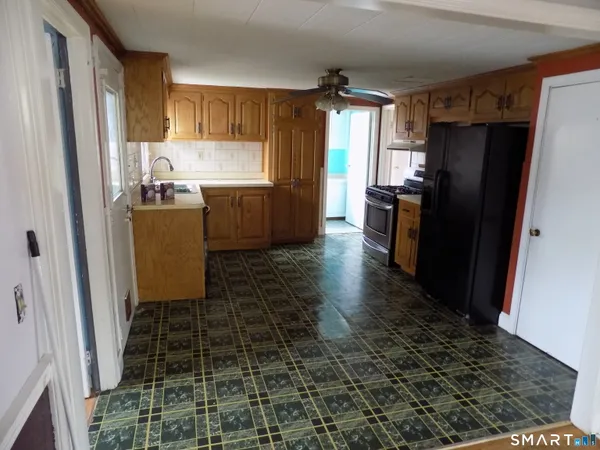 a kitchen with granite countertop a refrigerator and a sink
