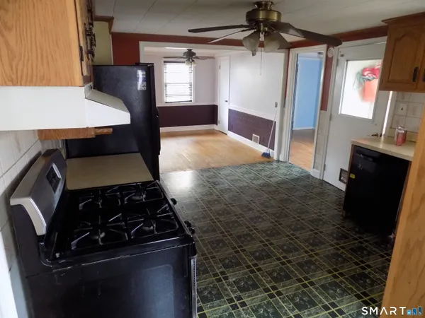 a kitchen with a stove and a refrigerator