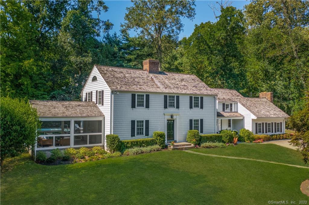 95 Cavalry Road Westport, CT 06880 - Photo 1 of 1 a front view of a house with a garden and porch