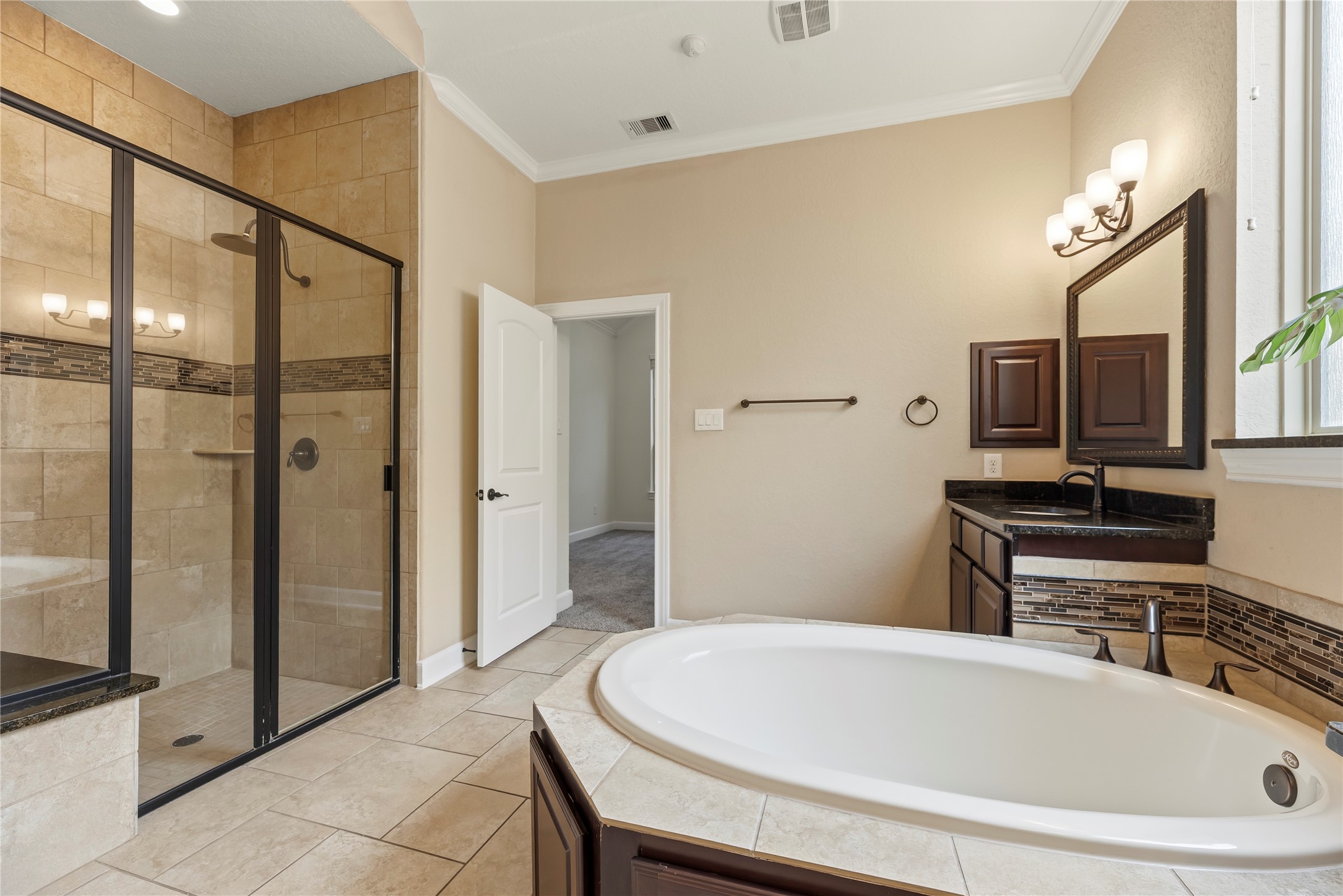 9915 Rochs Hill Court Katy, TX 77494 - Photo 15 of 32 a bathroom with a bathtub and a shower