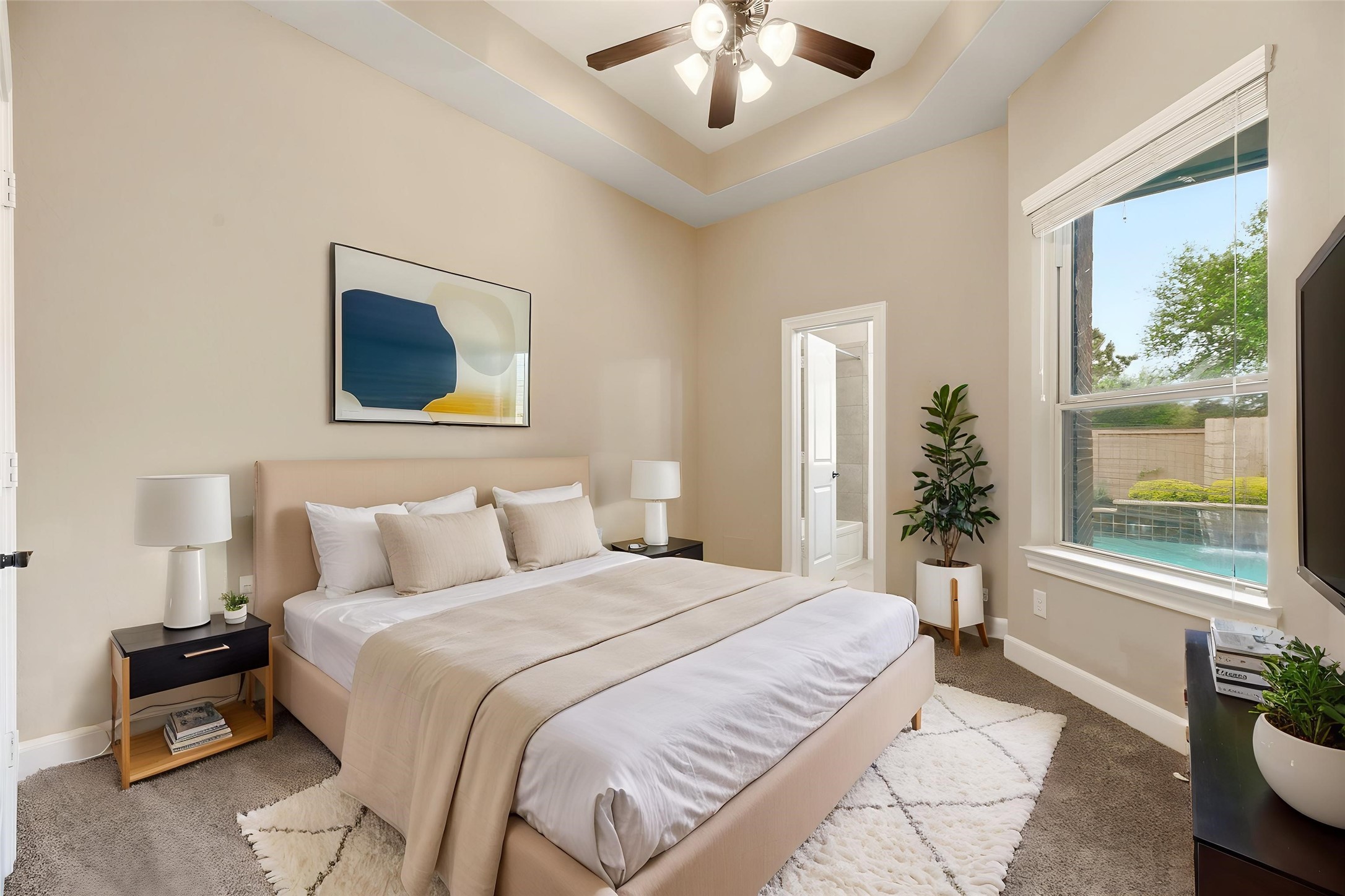 9915 Rochs Hill Court Katy, TX 77494 - Photo 16 of 32 a bedroom with a large bed and a chandelier