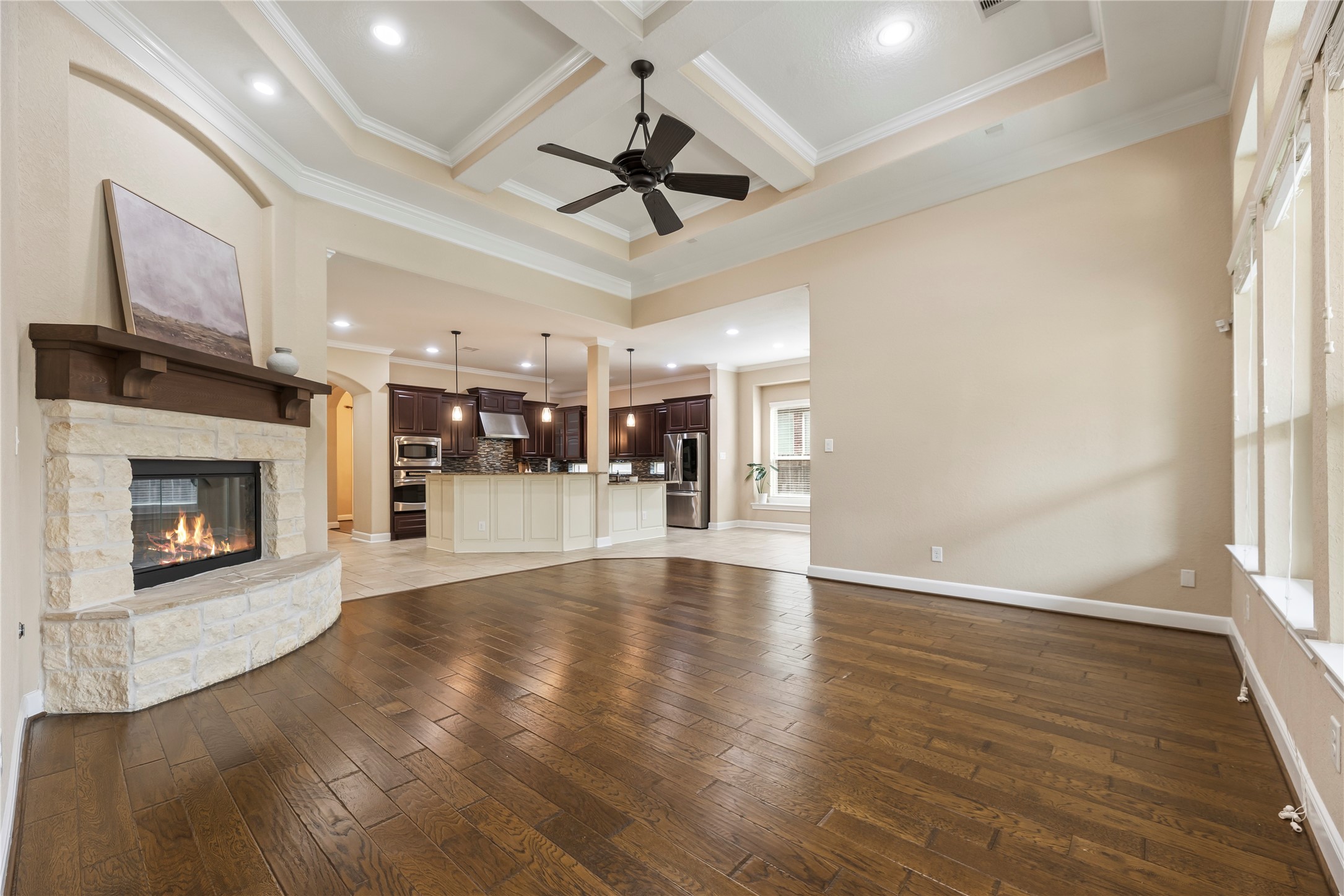 9915 Rochs Hill Court Katy, TX 77494 - Photo 7 of 32 a view of an empty room with wooden floor fireplace and a window