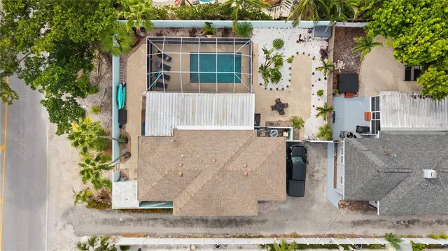 a backyard of a house with a garden and outdoor seating