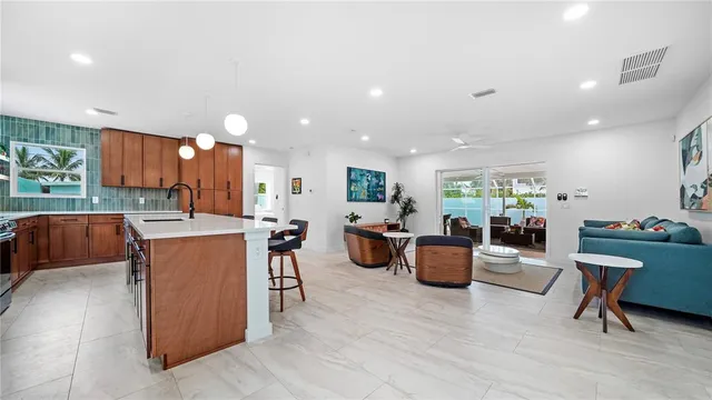 a kitchen with stainless steel appliances granite countertop a sink refrigerator and cabinets
