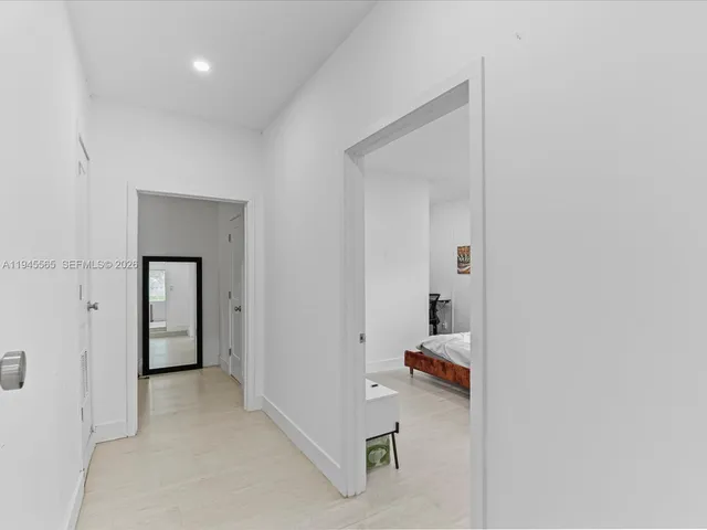 a view of a hallway to rooms and stairs