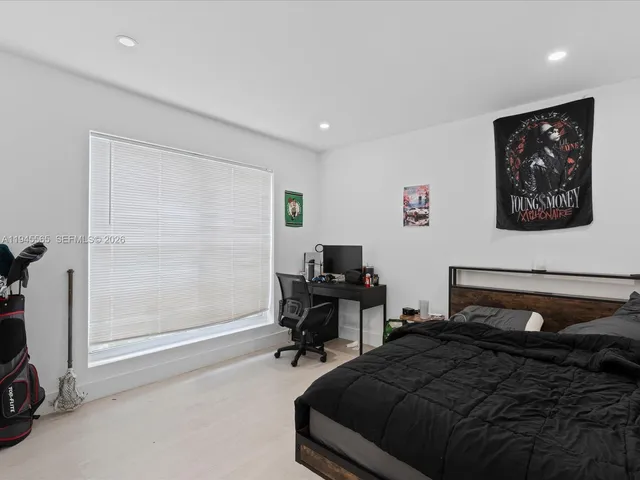 a bedroom with a bed and a desk