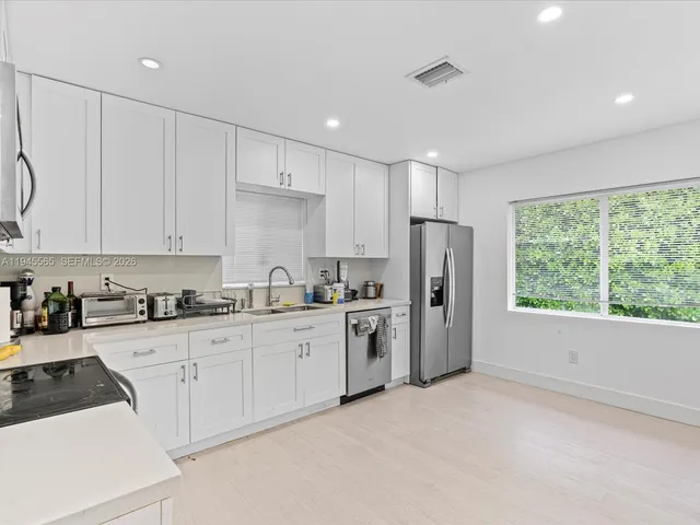 a kitchen with appliances cabinets and a sink