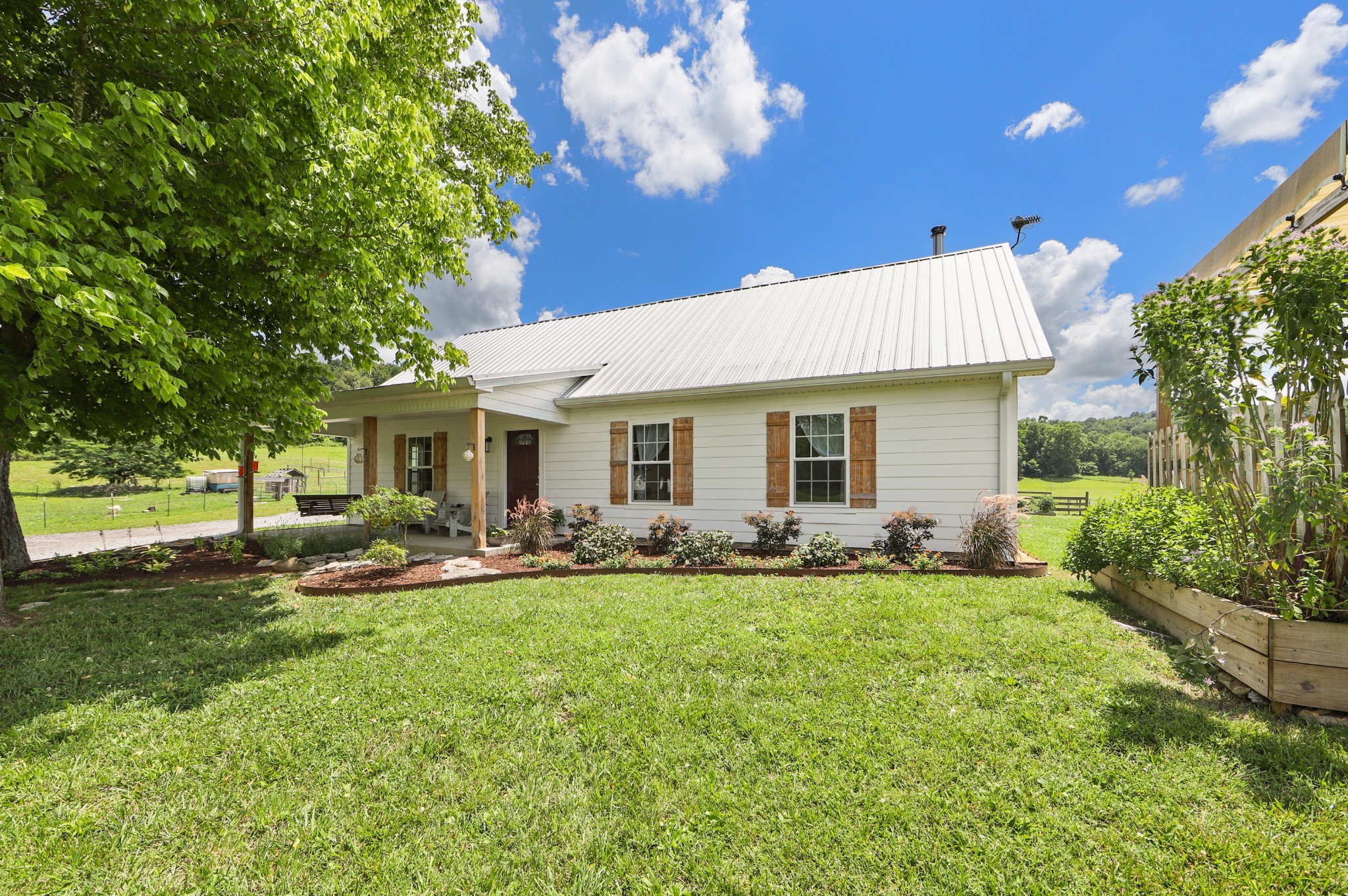 a front view of a house with a yard and trees