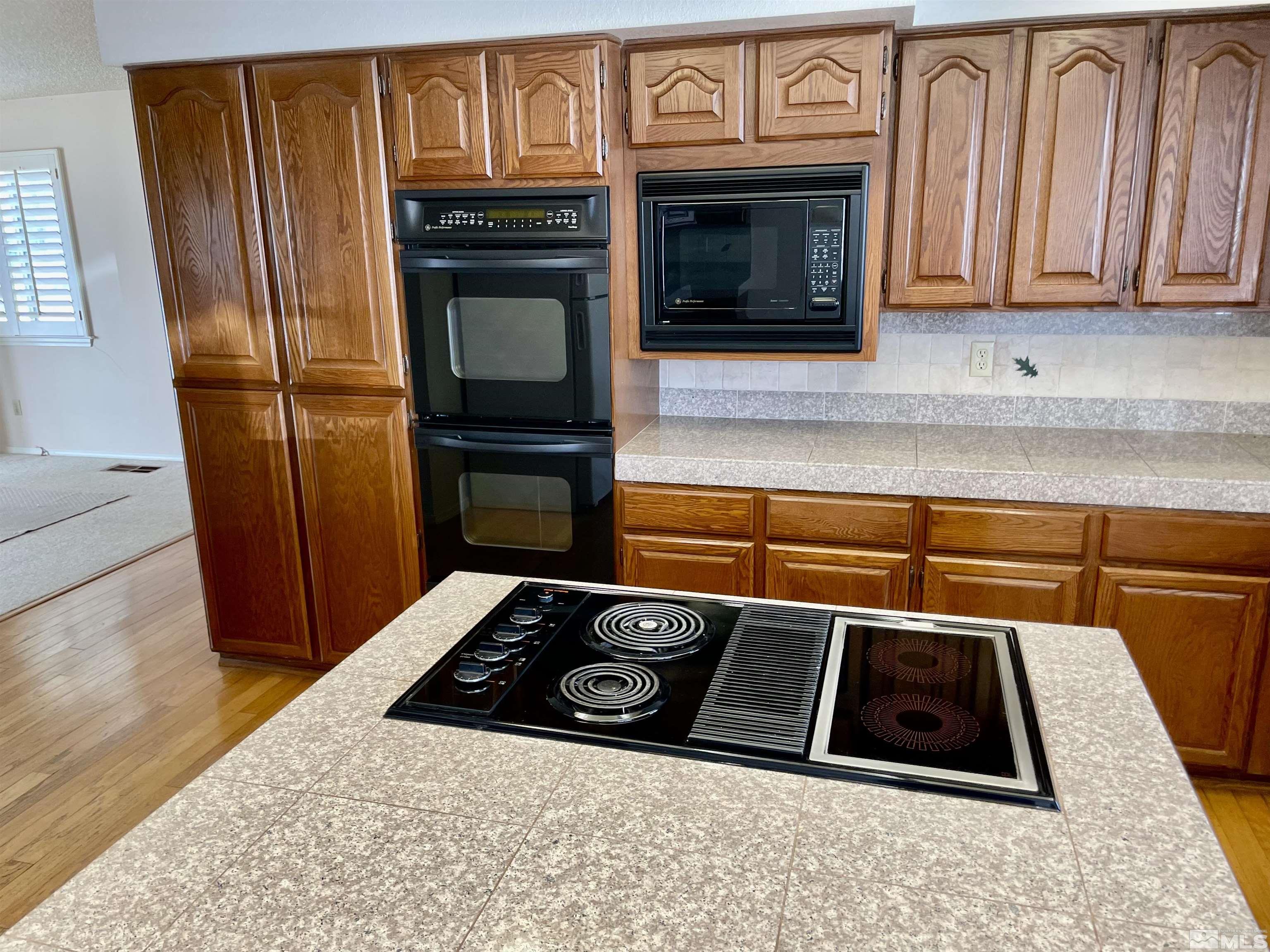 155 Cedar Lane Reno, NV 89521 - Photo 11 of 30 a kitchen with granite countertop stainless steel appliances and wooden cabinets