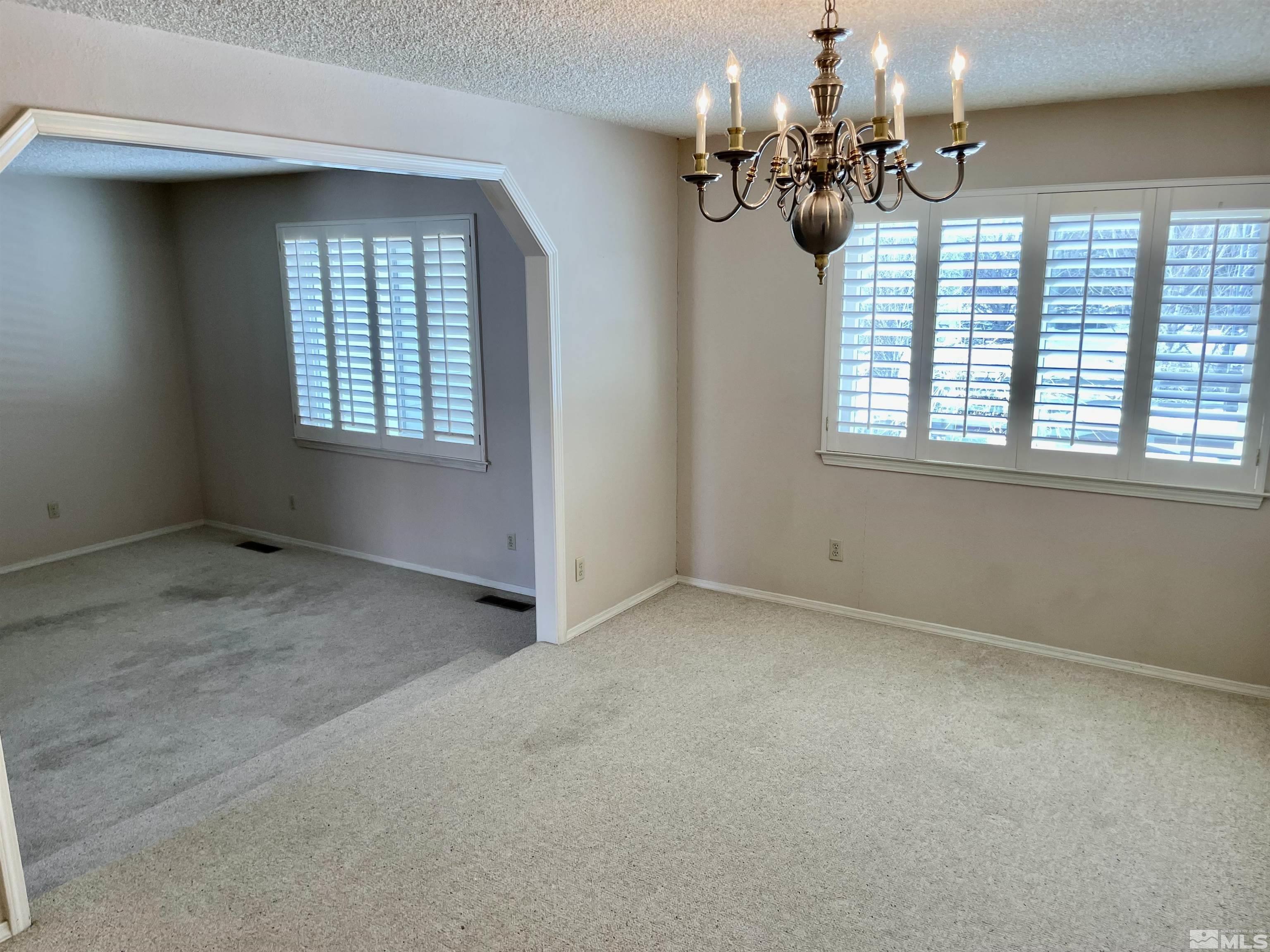 155 Cedar Lane Reno, NV 89521 - Photo 15 of 30 an empty room with a chandelier