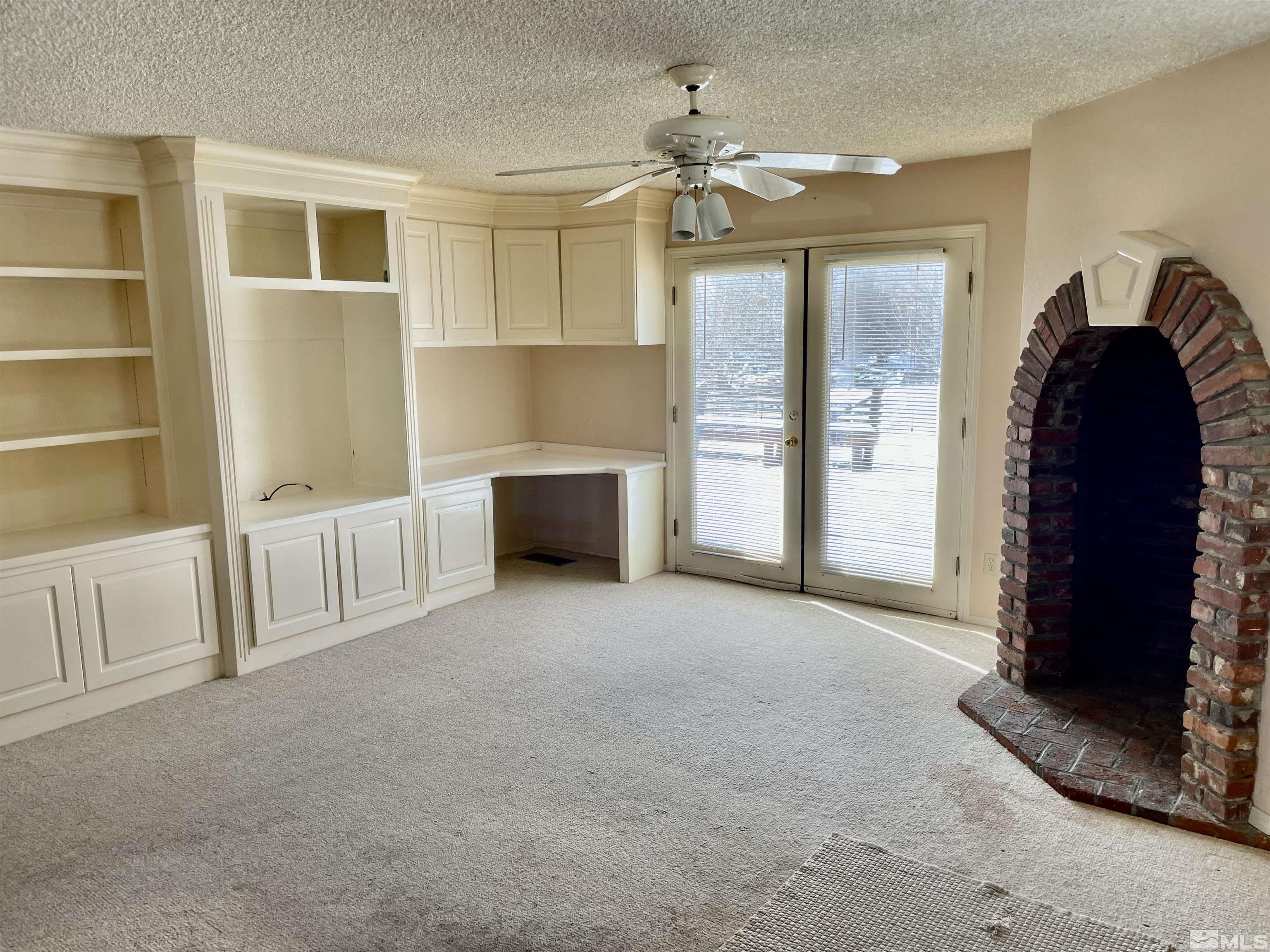 155 Cedar Lane Reno, NV 89521 - Photo 16 of 30 a view of an empty room with a fireplace and a window