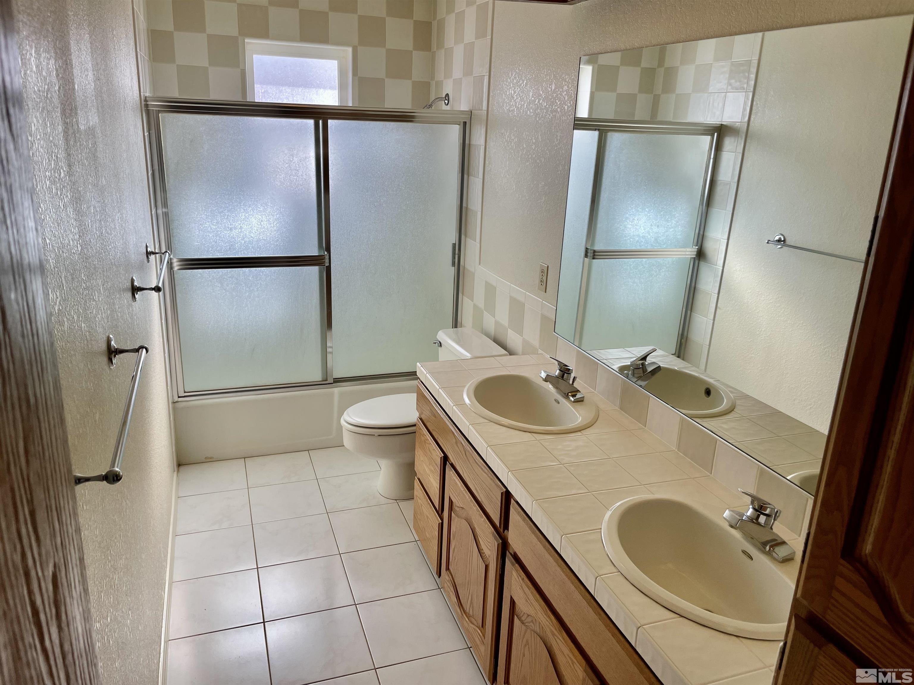 155 Cedar Lane Reno, NV 89521 - Photo 25 of 30 a bathroom with a sink a toilet and a mirror