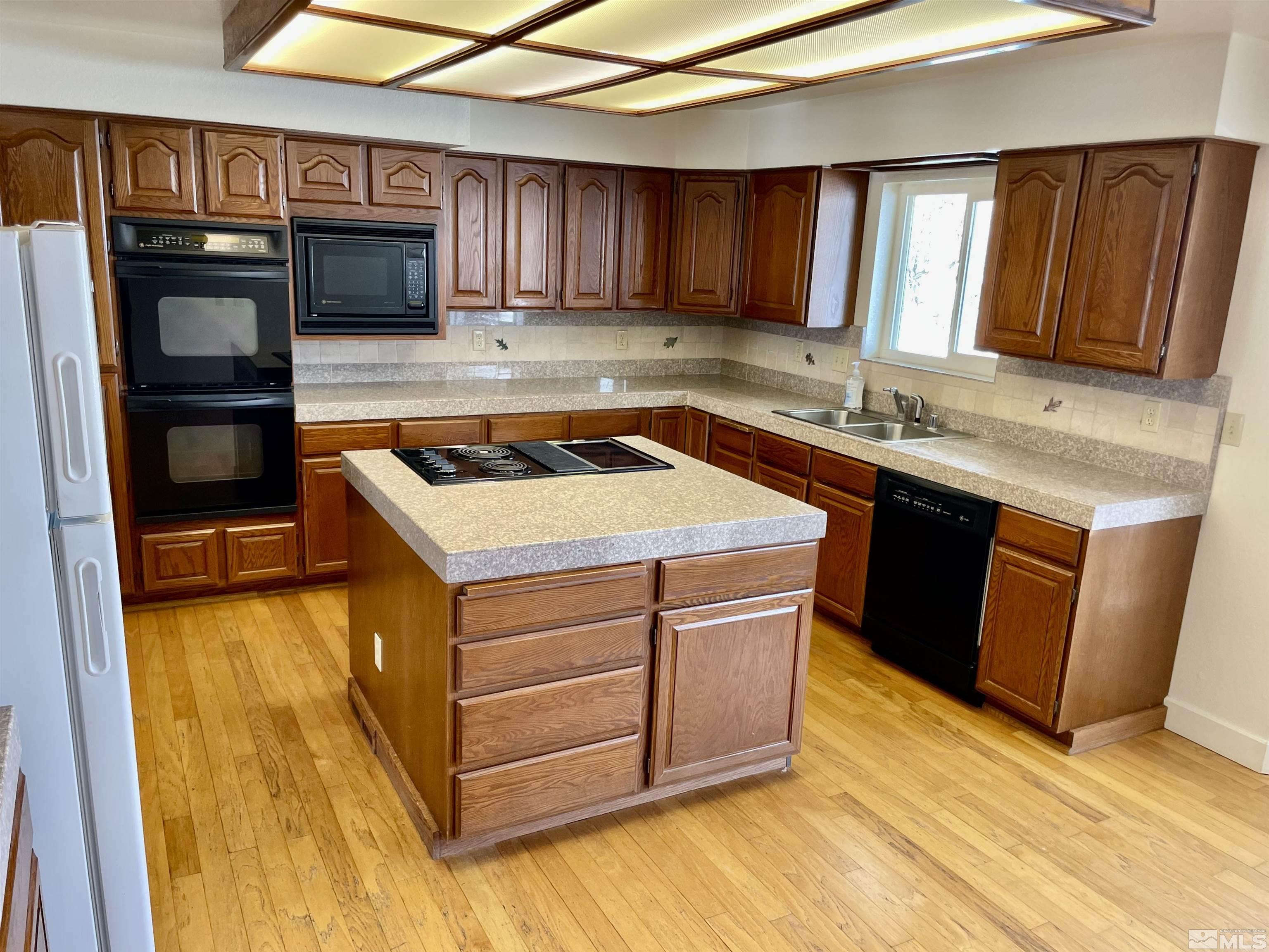 155 Cedar Lane Reno, NV 89521 - Photo 8 of 30 a kitchen with stainless steel appliances granite countertop a sink stove and cabinets