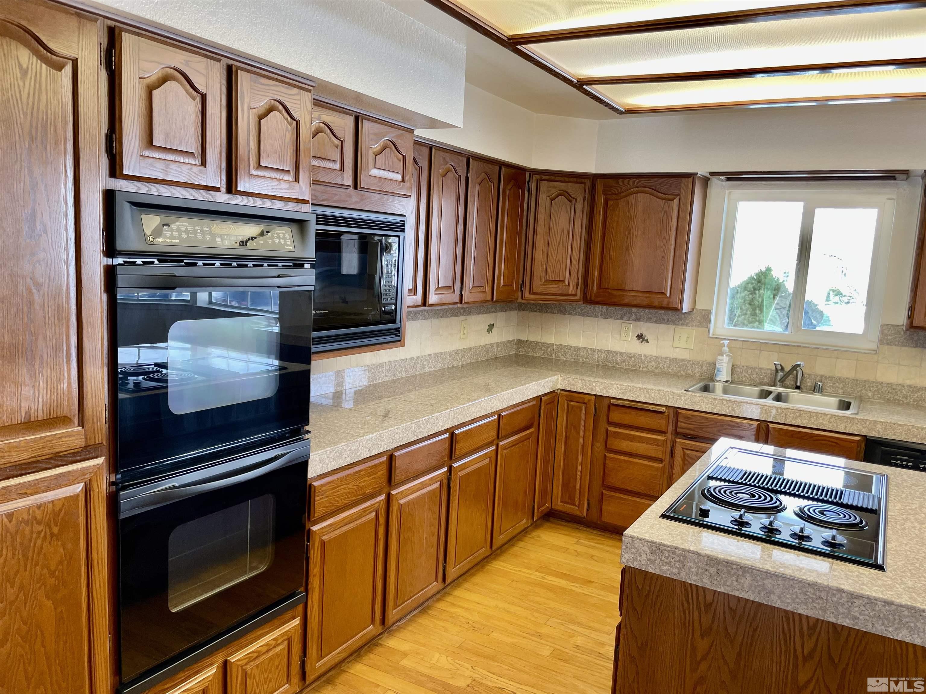 155 Cedar Lane Reno, NV 89521 - Photo 10 of 30 a kitchen with stainless steel appliances granite countertop a stove and a sink