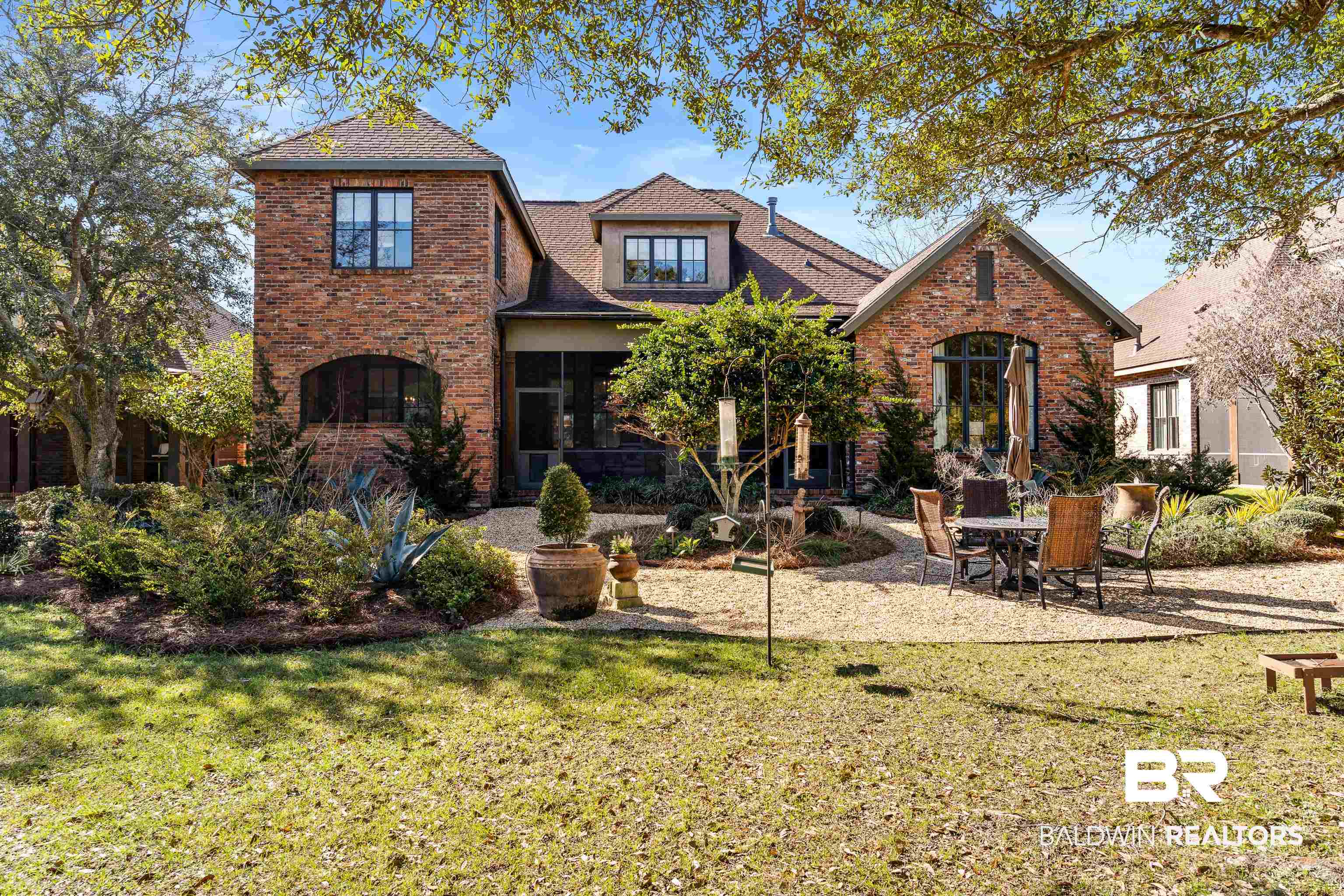 3613 Old Park Road Gulf Shores, AL 36542 - Photo 64 of 72 View of front of home featuring a front yard, a patio area, brick siding, and roof with shingles