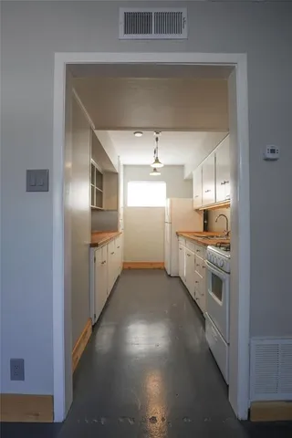 a large kitchen with cabinets and stainless steel appliances