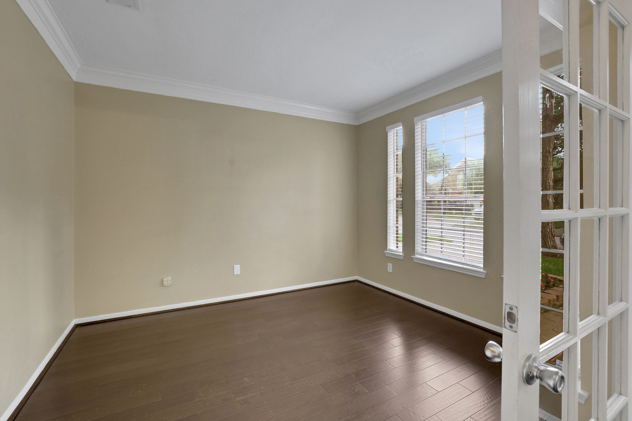 23207 Olive Ridge Court Katy, TX 77494 - Photo 4 of 46 an empty room with wooden floor and windows